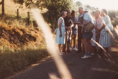 A group of people standing in the way during the day
